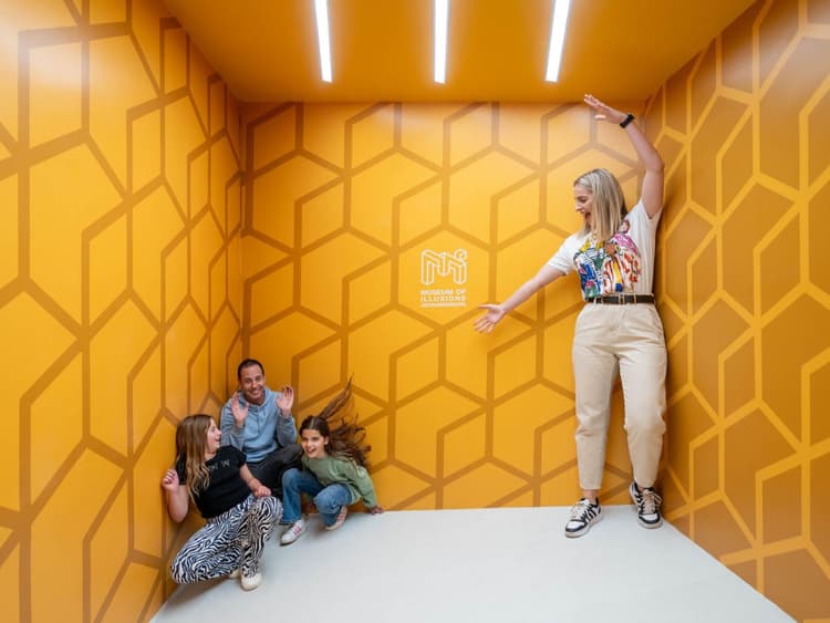A woman standing on top of a white floor next to a group of people