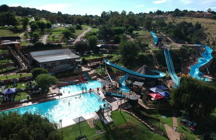 An aerial view of a water park with a water slide