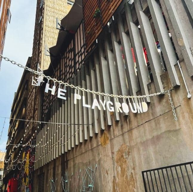 A building with a sign that says the playground on it