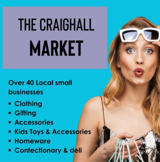 A woman holding a shopping bag and wearing sunglasses