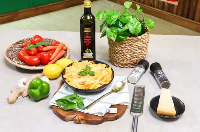 A table topped with a bowl of food and a bottle of wine