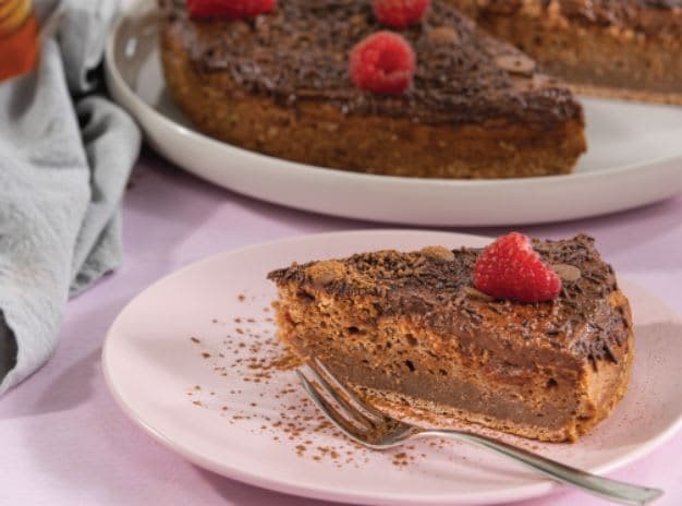 A piece of chocolate cake on a plate with a fork