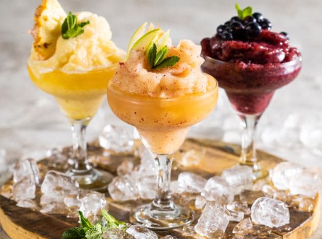 Three different types of ice cream on a wooden tray