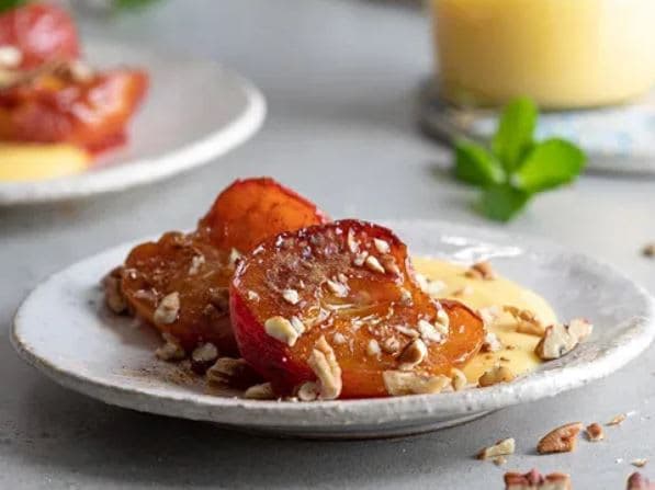 A white plate topped with fruit and nuts